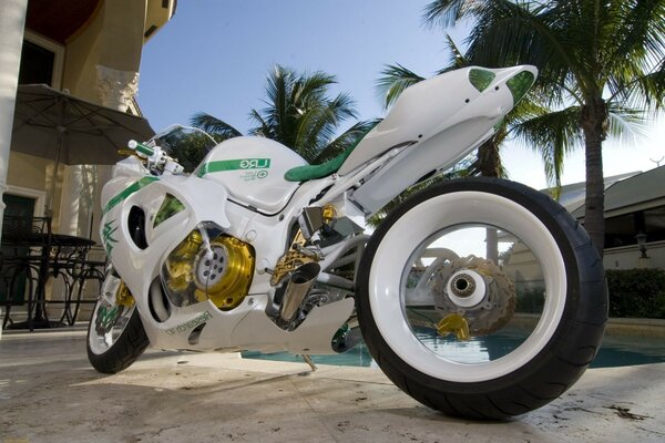 White fashionable motorcycle on the street in the tropics