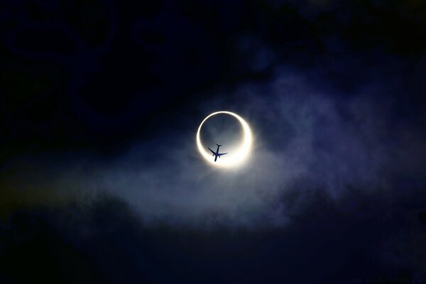 A plane on the background of a solar eclipse