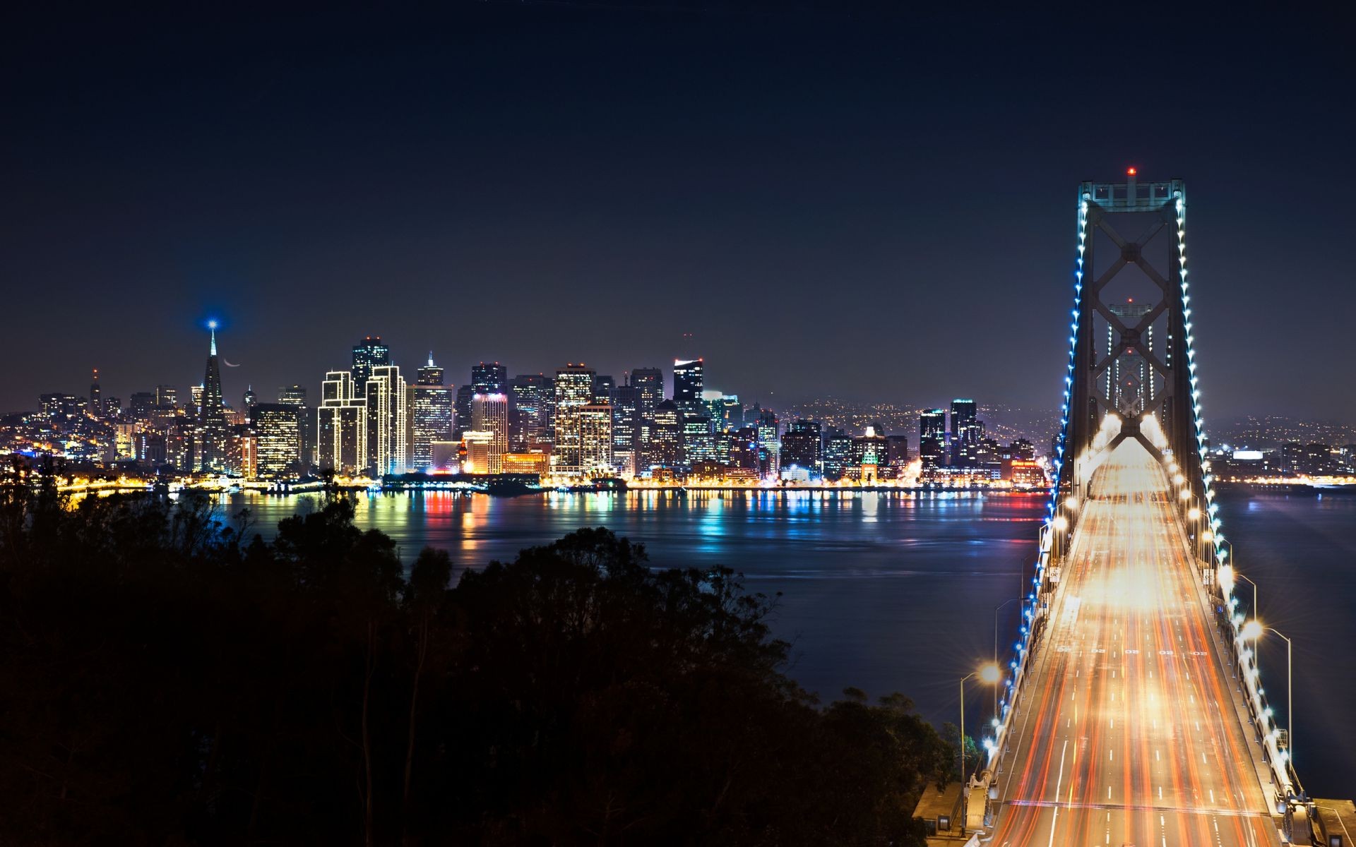 bridges city bridge architecture skyline cityscape travel dusk water evening sunset river sky skyscraper urban downtown building tower business reflection