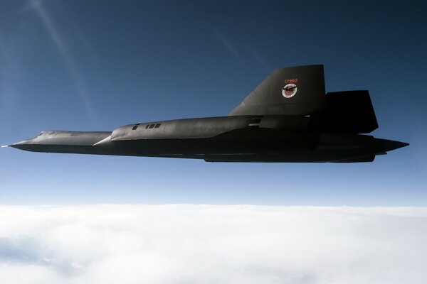 Military aircraft of dark color on the background of the sky