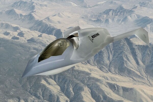 A military fighter against the background of snow-capped mountains