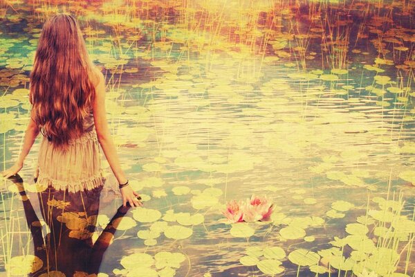 Beautiful girl bathing in a pond