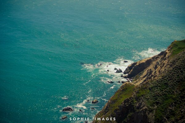 Sea surf at the foot of the mountain