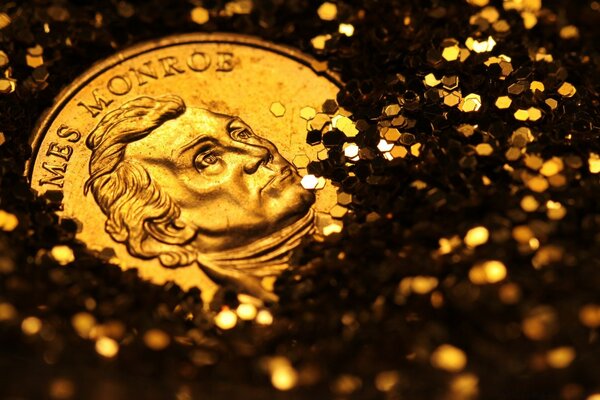 A coin among gold coins. The image on the coin