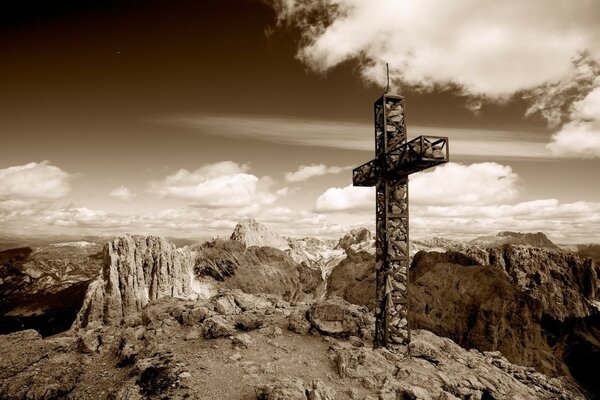 Kreuz auf dem Hintergrund des Himmels und der Berge