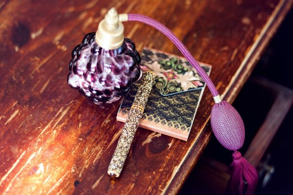 Beautiful lilac perfume on the table