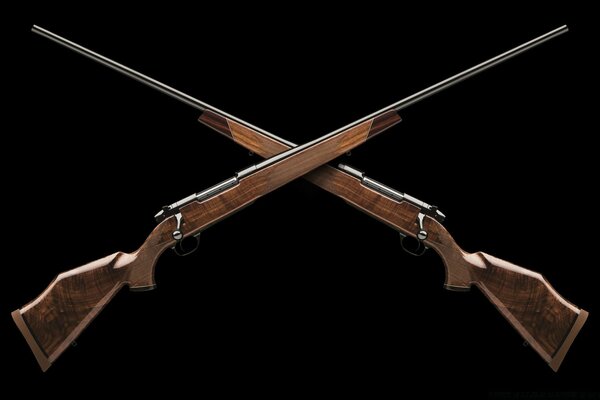 Two hunting rifles on a black background