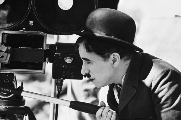 Charlie Chaplin in a bowler hat look at the cameras