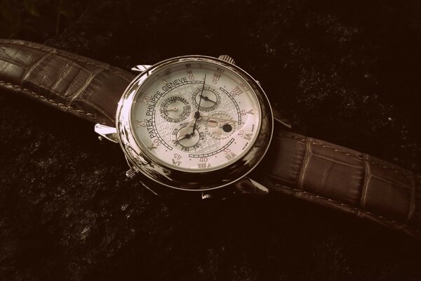 Silver watch with brown strap and white dial