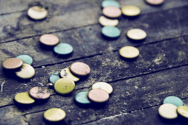 Round multicolored objects on dark wooden boards