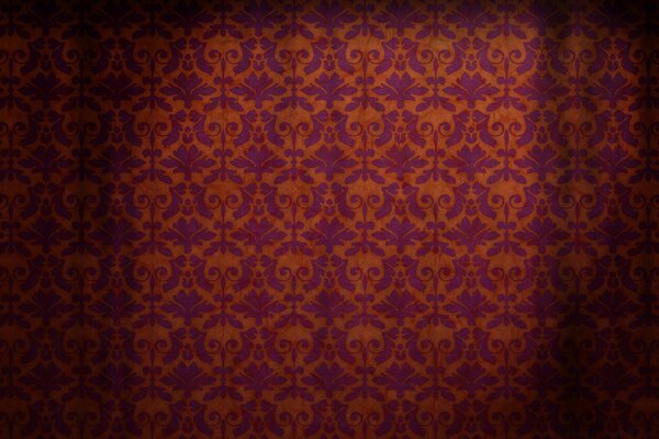 Antique wallpaper with an intricate pattern of orange and purple shades