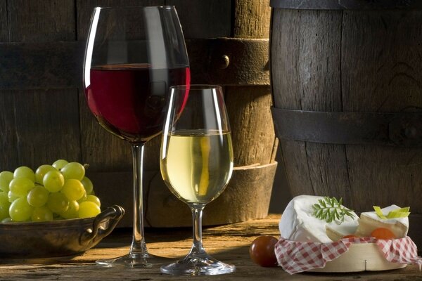 Wine cheese glasses white grapes red barrels