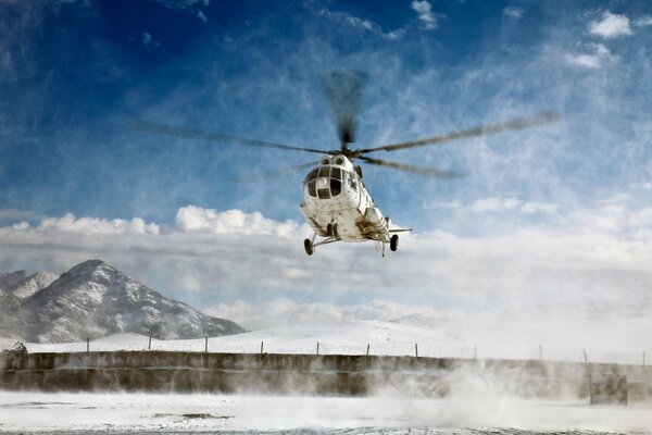 Helicopter in the blue sky in winter