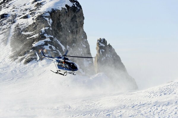 Helicóptero decola em uma montanha coberta de neve