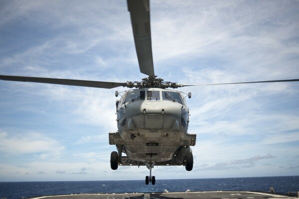 Helicopter over the take-off area on the ship