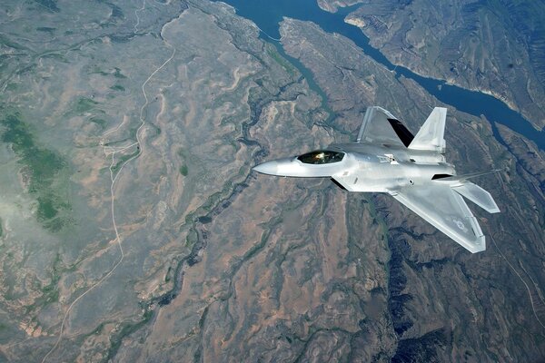 A fighter flying over the globe