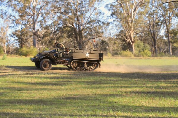 An army car on a training exercise in the forest