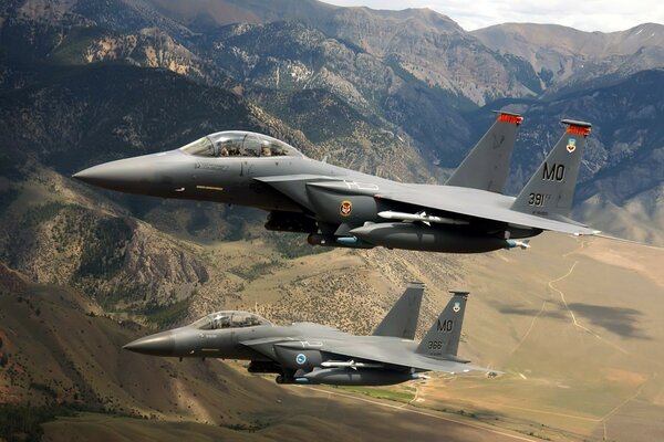 Military planes fly over the mountains