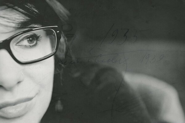 Black and white photo of a girl with glasses