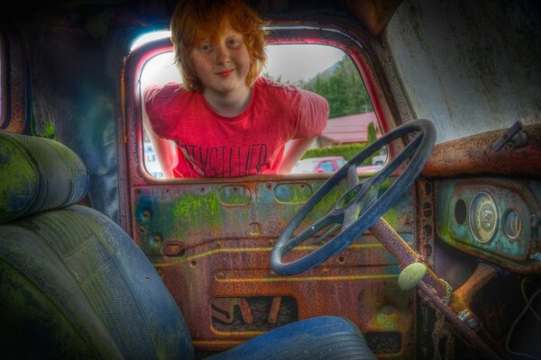 Redhead boy and vintage car