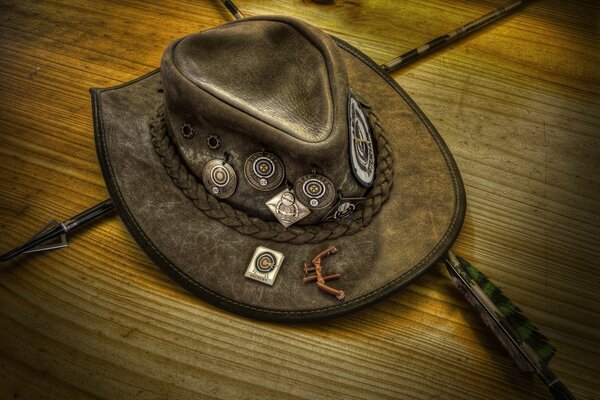 Vintage hat with arrows on a wooden table