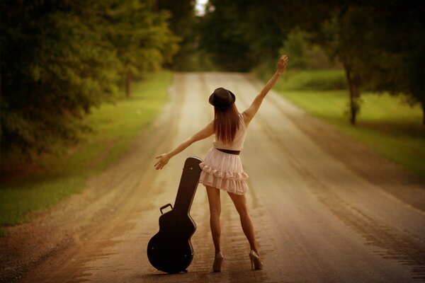 Romantic adult girl with a guitar