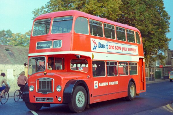 A double-decker red bus on the road