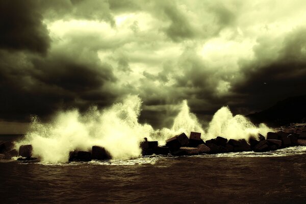 The sea waves are beating against the rocks