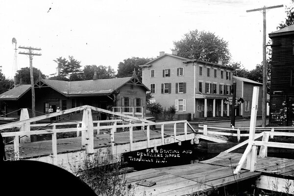 Black and white photo of houses near the bridge