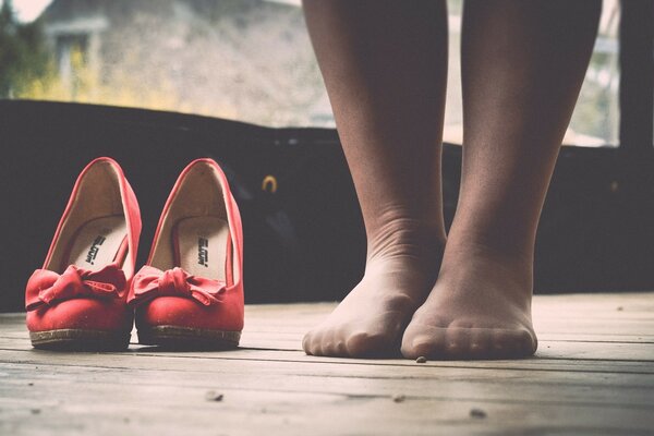 A woman s feet and shoes on the floor