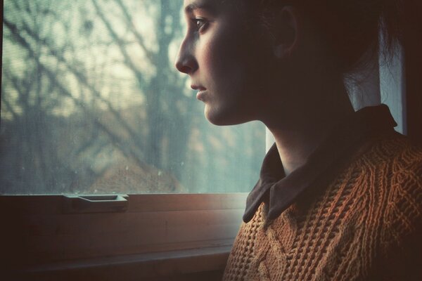 Portrait of a girl looking out the window