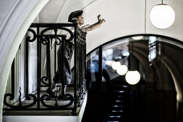 A man reaches for a round chandelier