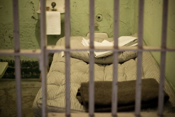 The interior of a prison cell through the bars