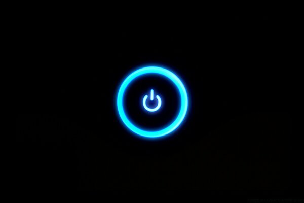 A glowing power-on icon on a dark background