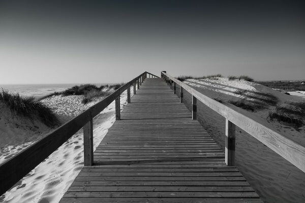 Bridge with sides on a sandy beach