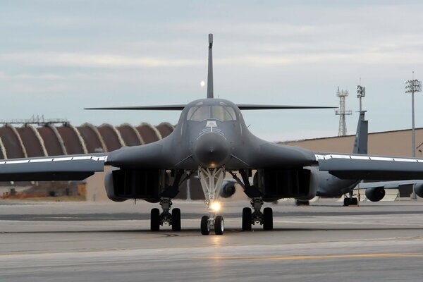 A military plane is taxiing for takeoff