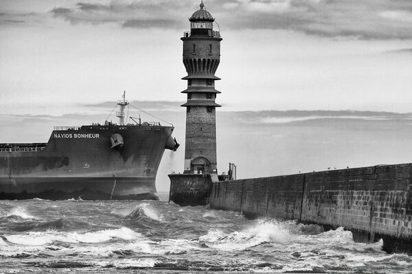 The ship enters the port with a lighthouse