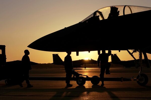 Night military airfield with a fighter silhouette