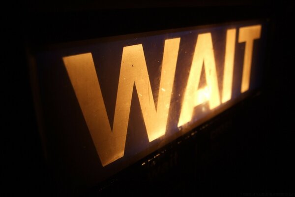 The wait sign on a black background