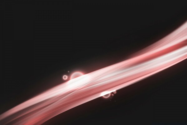 A pink-and-white jet pours in the dark