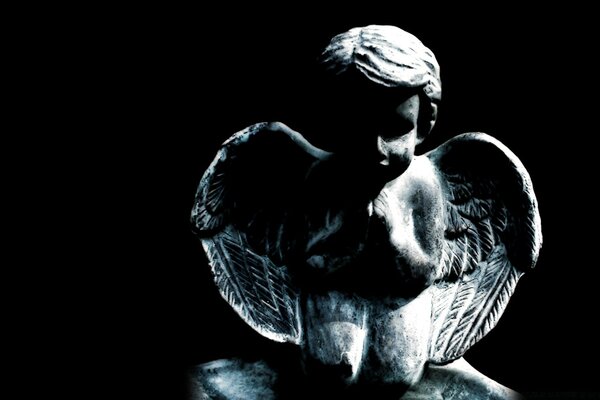 Sculpture of an angel on a black background