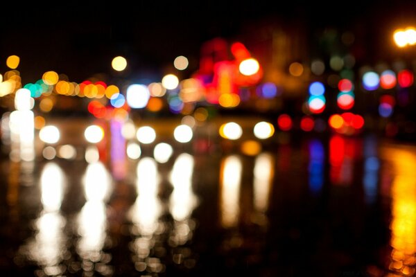 Night blurred multicolored lights reflected in the water