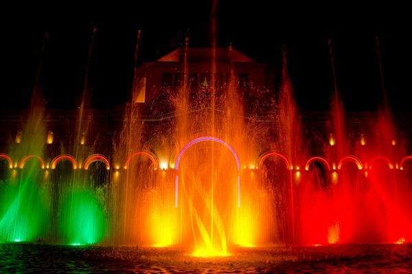 Energetic dance of illuminated night fountains