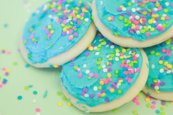 Sweets with cream and multicolored sprinkles