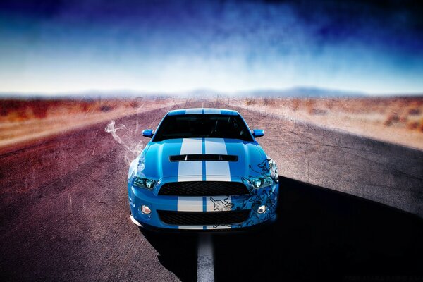 A blue car rushes through the desert