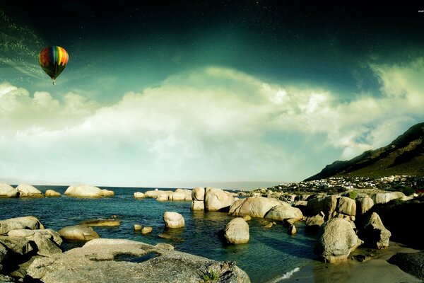 Balloon on the background of boulders and the sea