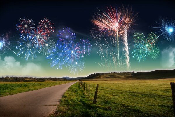 A road and a field against the sky with a multicolored fireworks display