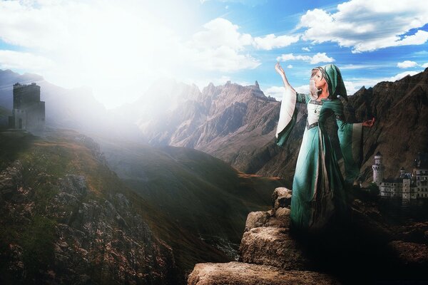 A girl in a cape stands on a mountain