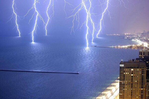 Lightning discharges in the sea off the coast of the city