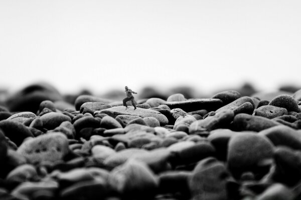 A little man runs over big rocks